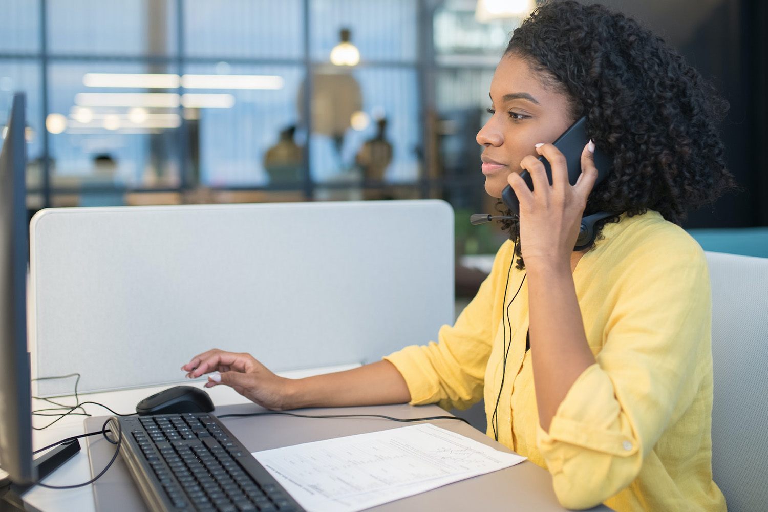 Woman On The Phone And Using A Computer