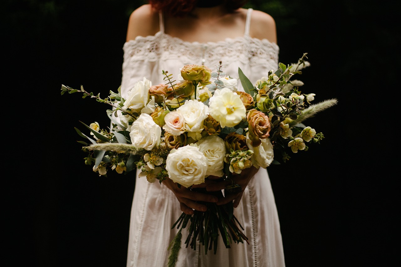 Bride in lace dress holding a bouquet of flowers