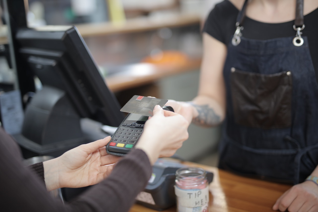 Woman is paying at store with credit card.