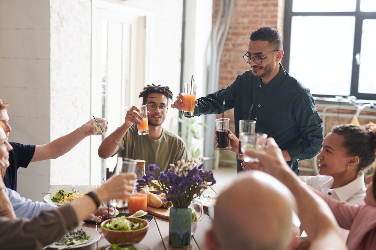 Group of people having a lunch and having a toast.