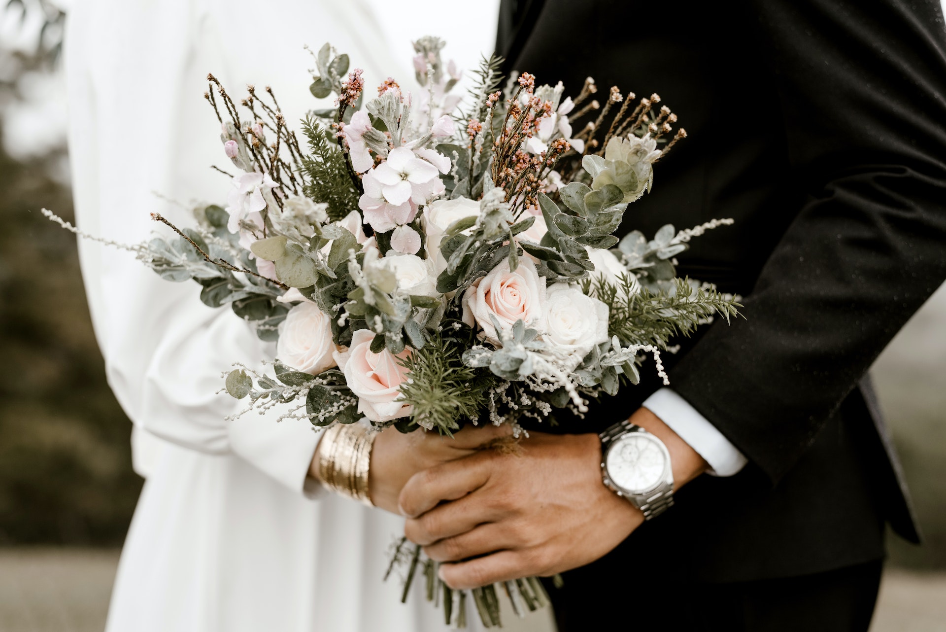 bridge and groom in wedding wear standing next to each other