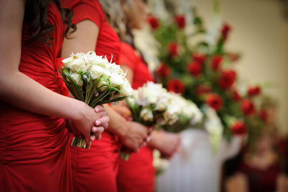 Row of bridesmaids in red dresses