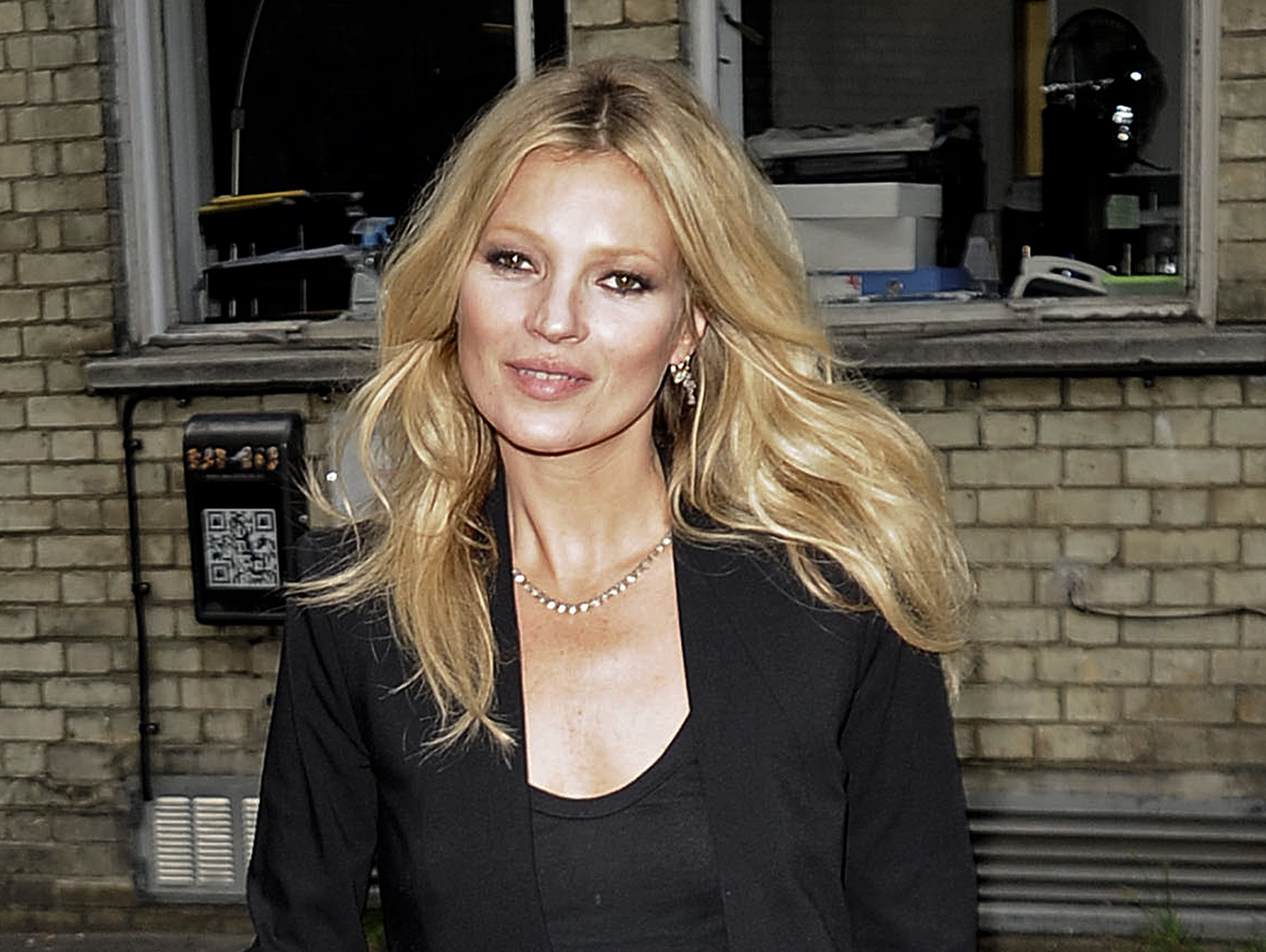 Kate Moss is looking at camera and smiling - 2012