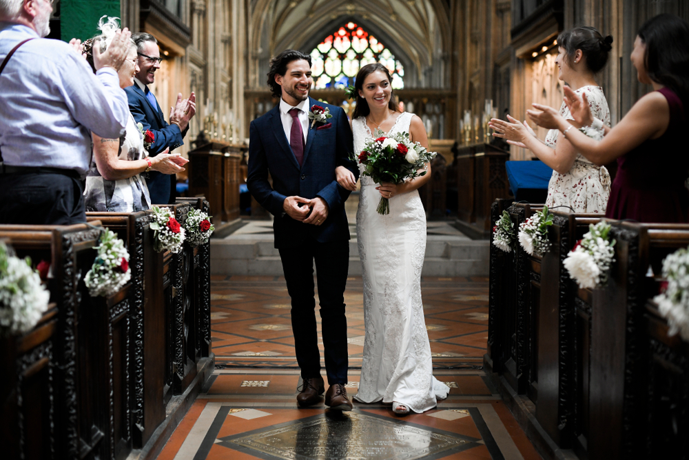 Newly wed couple walking down the aisle in church