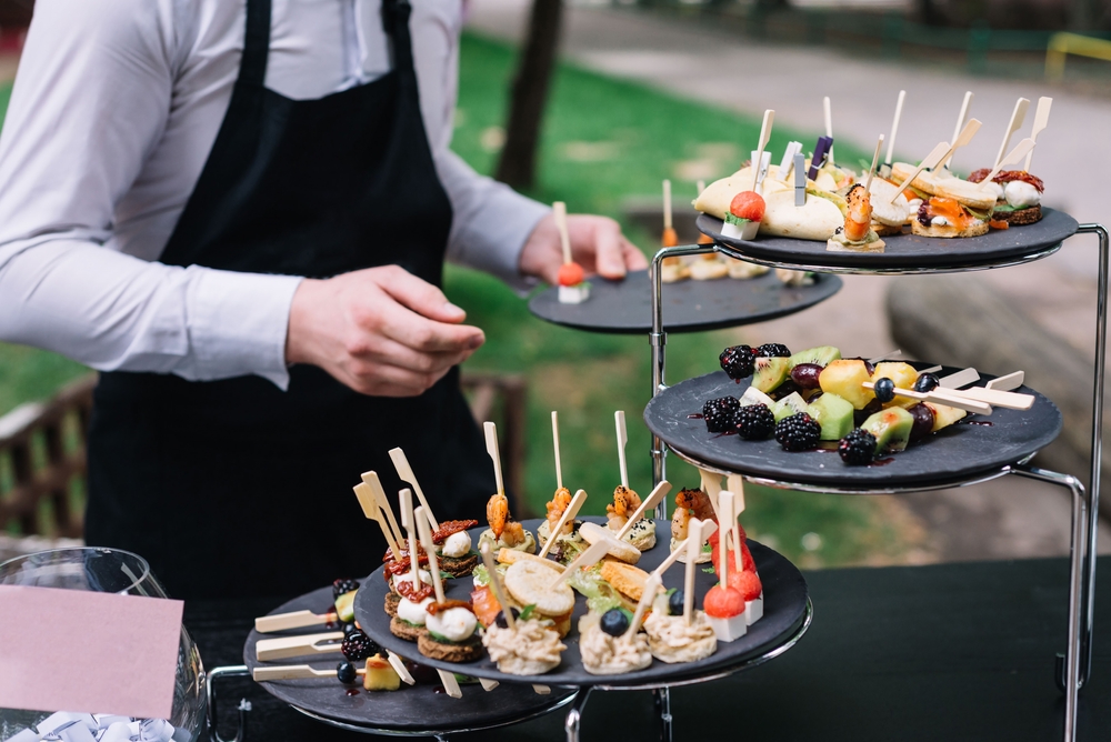 Waiter at wedding reception serving food