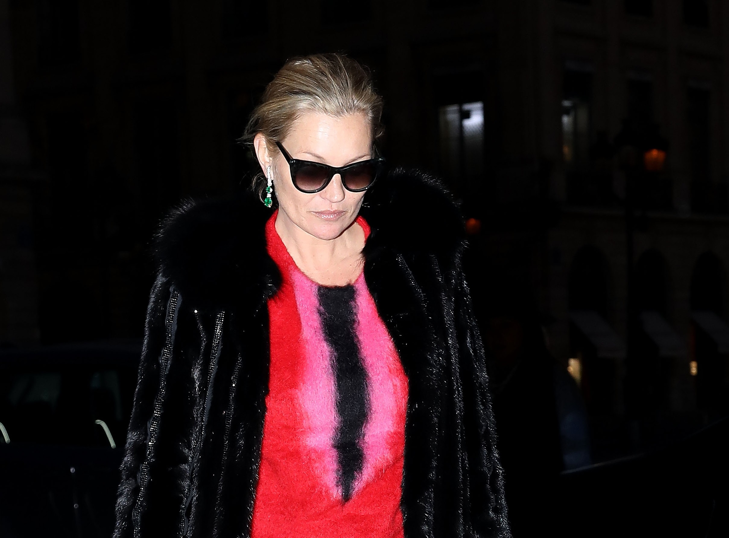Kate Moss with black coat and glasses walking on the street with sad face - 2017