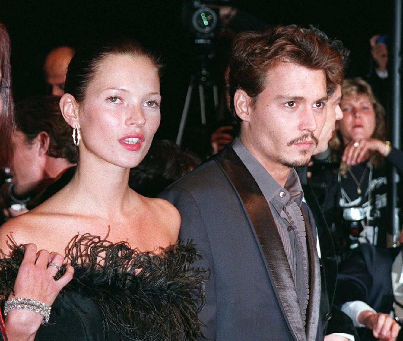 Kate Moss walking next to Johnny Deep,looking at side - 1998