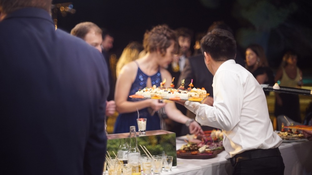 wedding guests serving themselves food and drinks