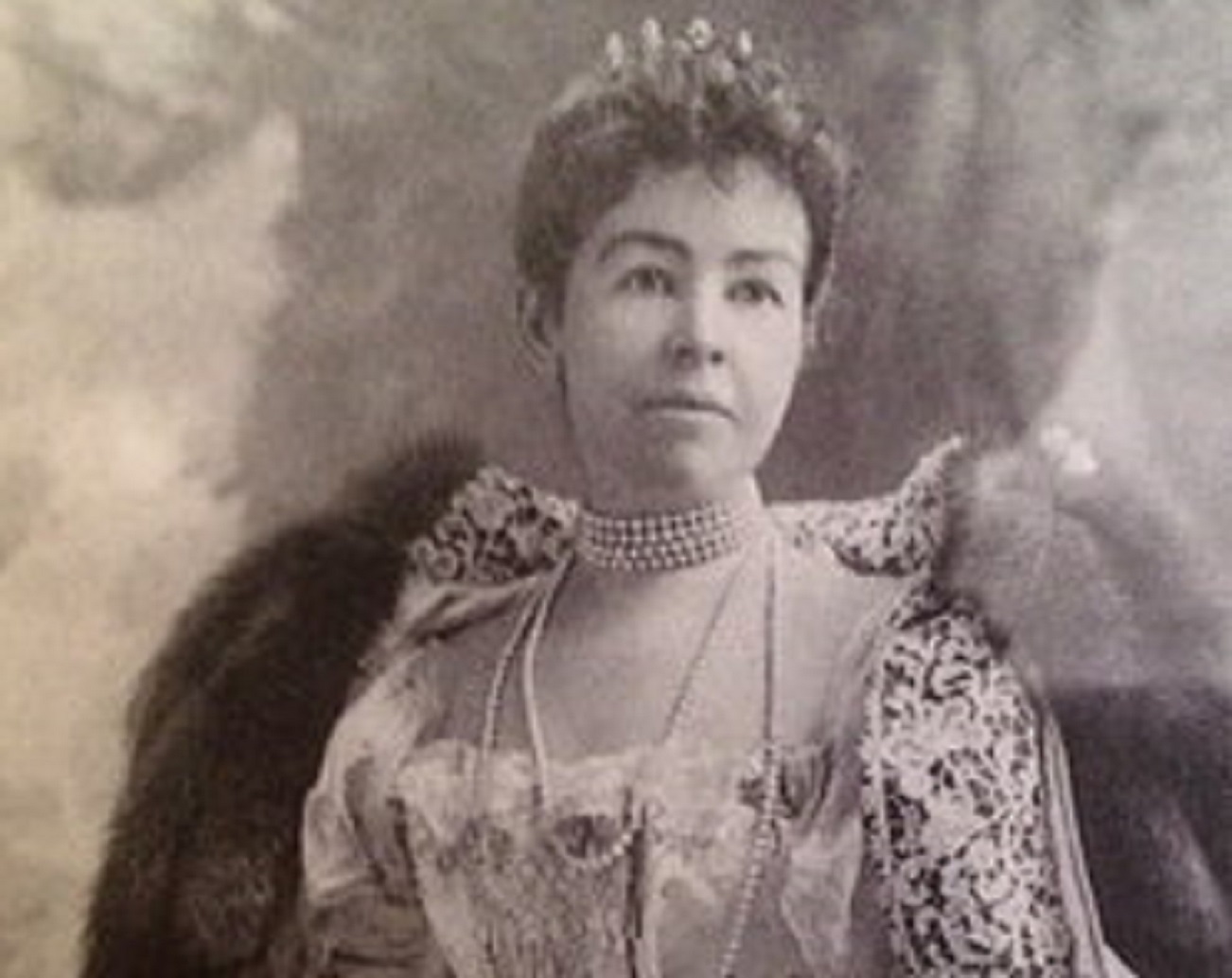 Portrait of Alice Claypoole Gwynne Vanderbilt wearing dress with fur coat ,looking at side.