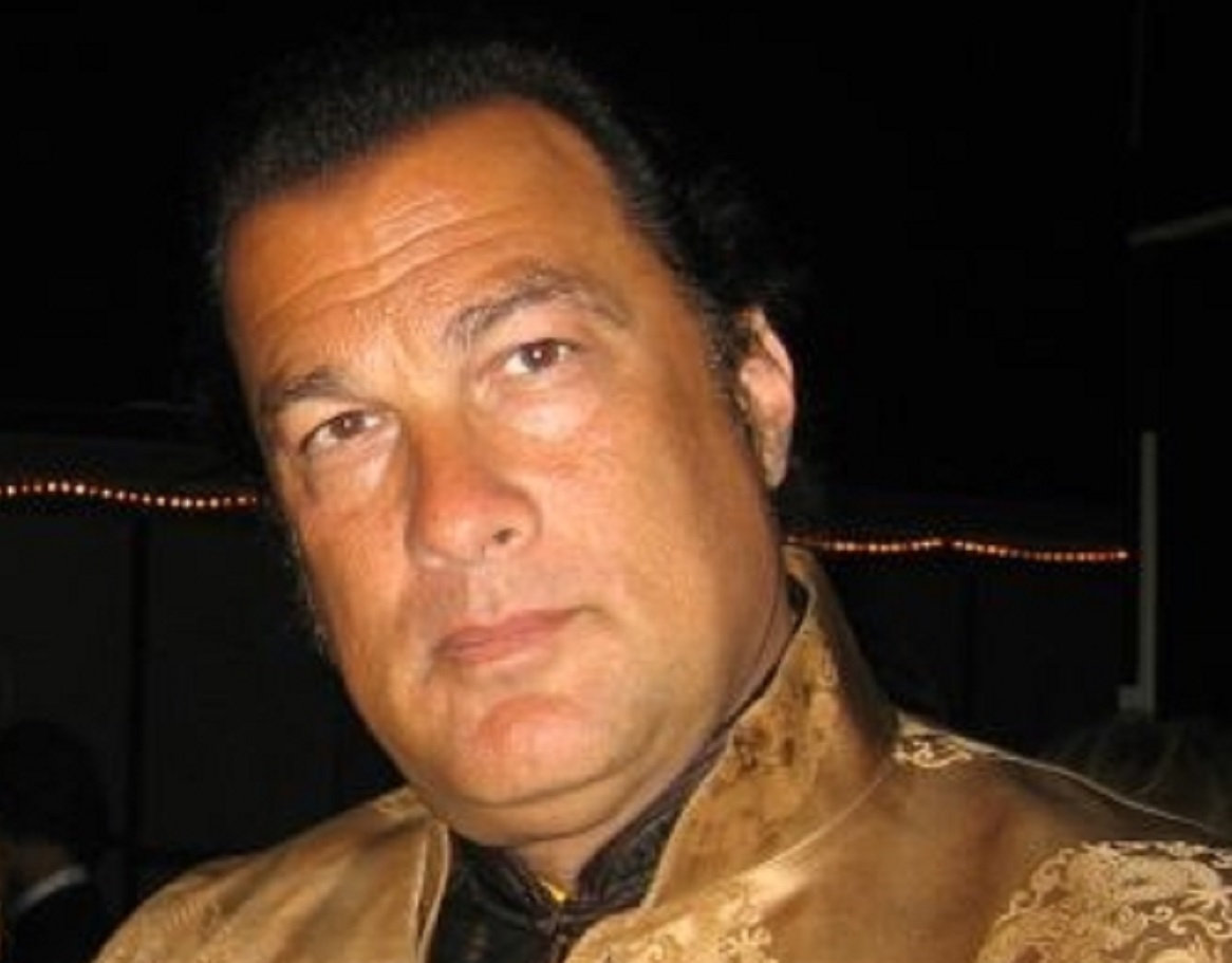 Steven Seagal is looking at camera on dark background - 2006
