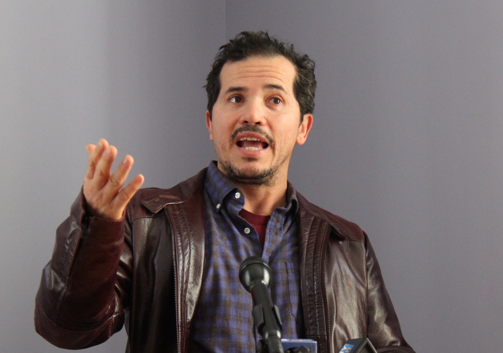 Actor John Leguizamo is talking on the microphone and looking at front - 2014