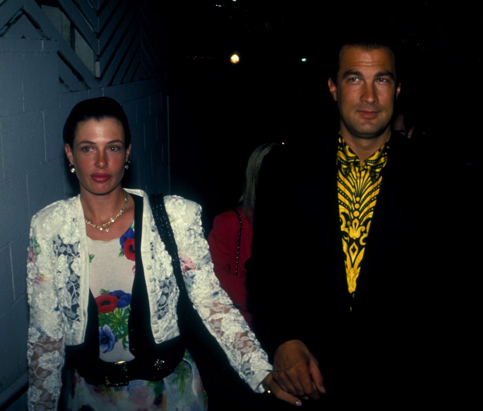 Actor Steven Seagal and his wife Kelly LeBrock are walking and looking at side - 1991