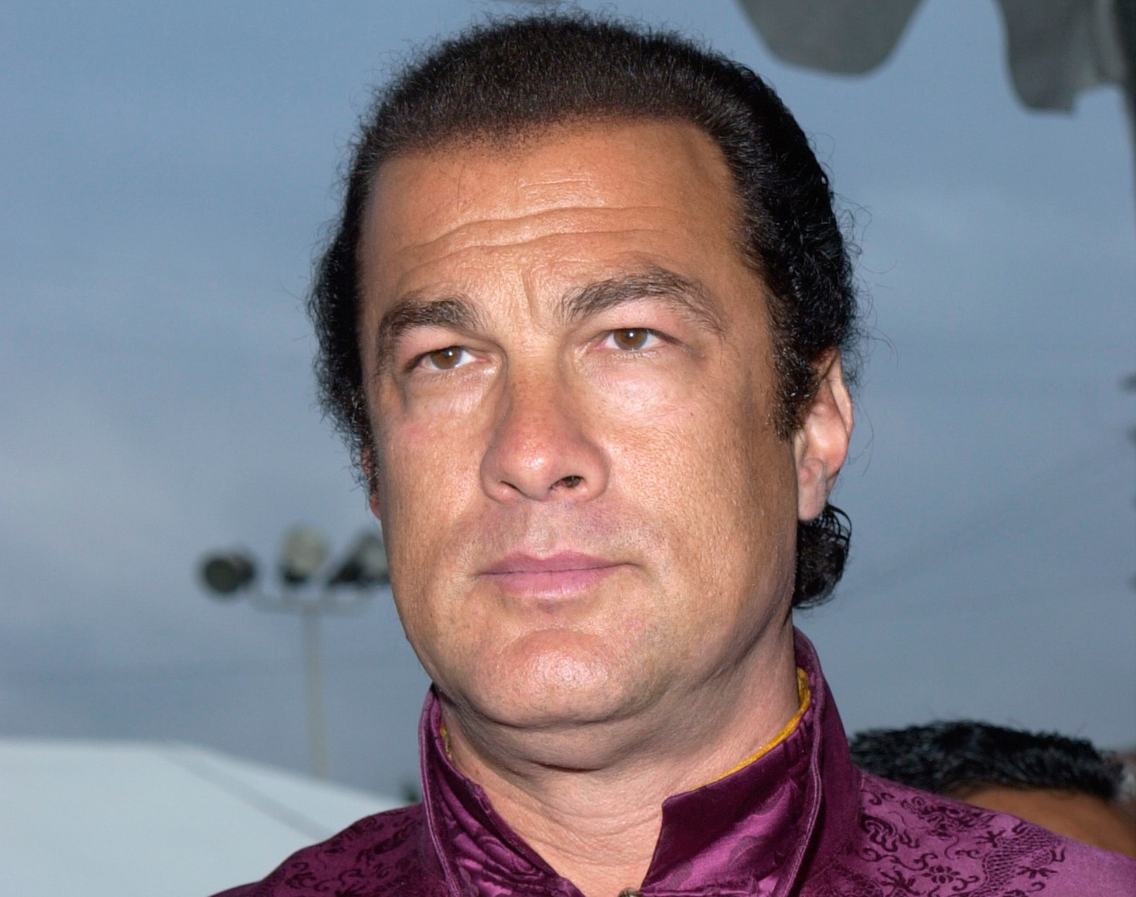 Steven Seagal is looking at side with upset face - 2001