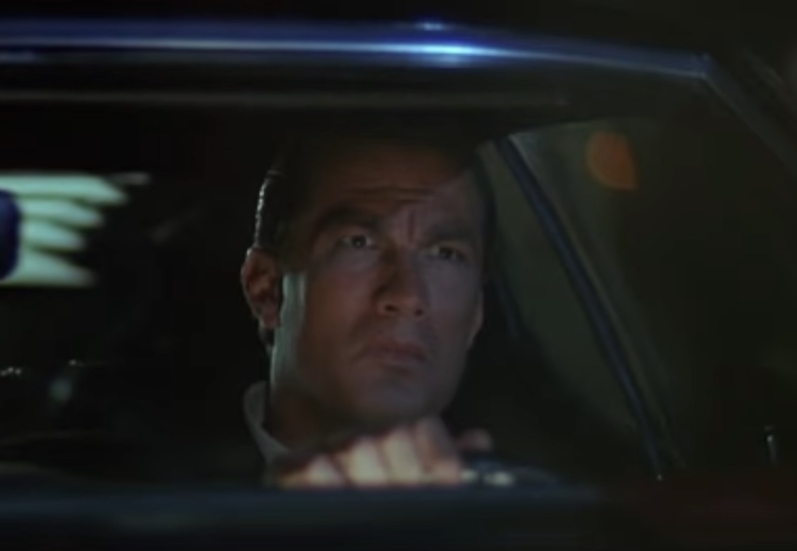 Screenshot: Steven Seagal is driving a car at night - from Marked For Death (1990)