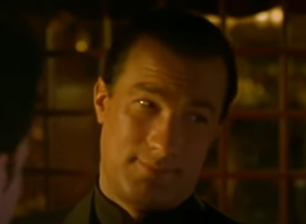 Screenshot: Steven Seagal is looking at side and smiling - from The Glimmer Man (1996)