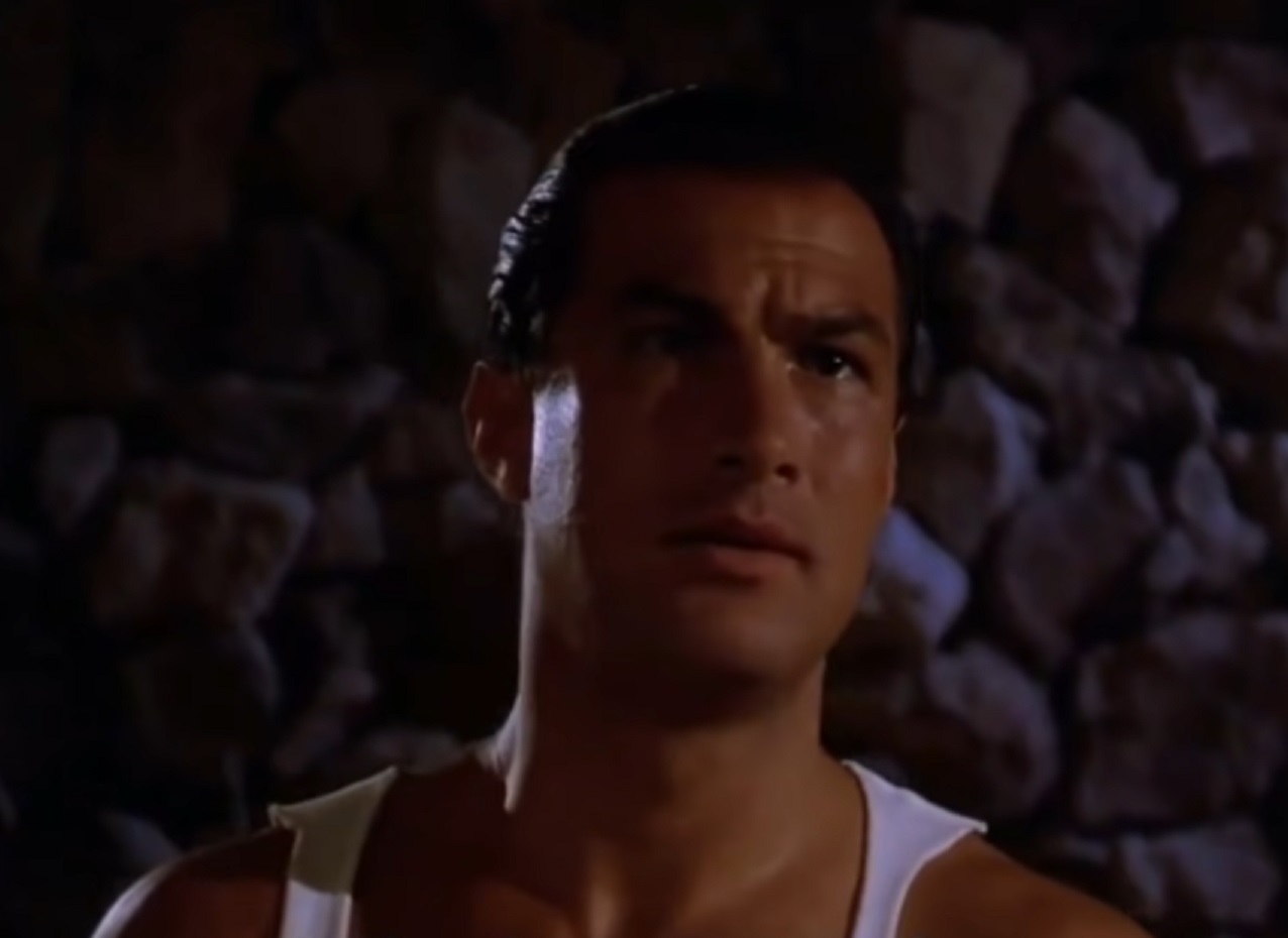Screenshot: Steven Seagal is looking at front at dark - from Hard To Kill (1990)