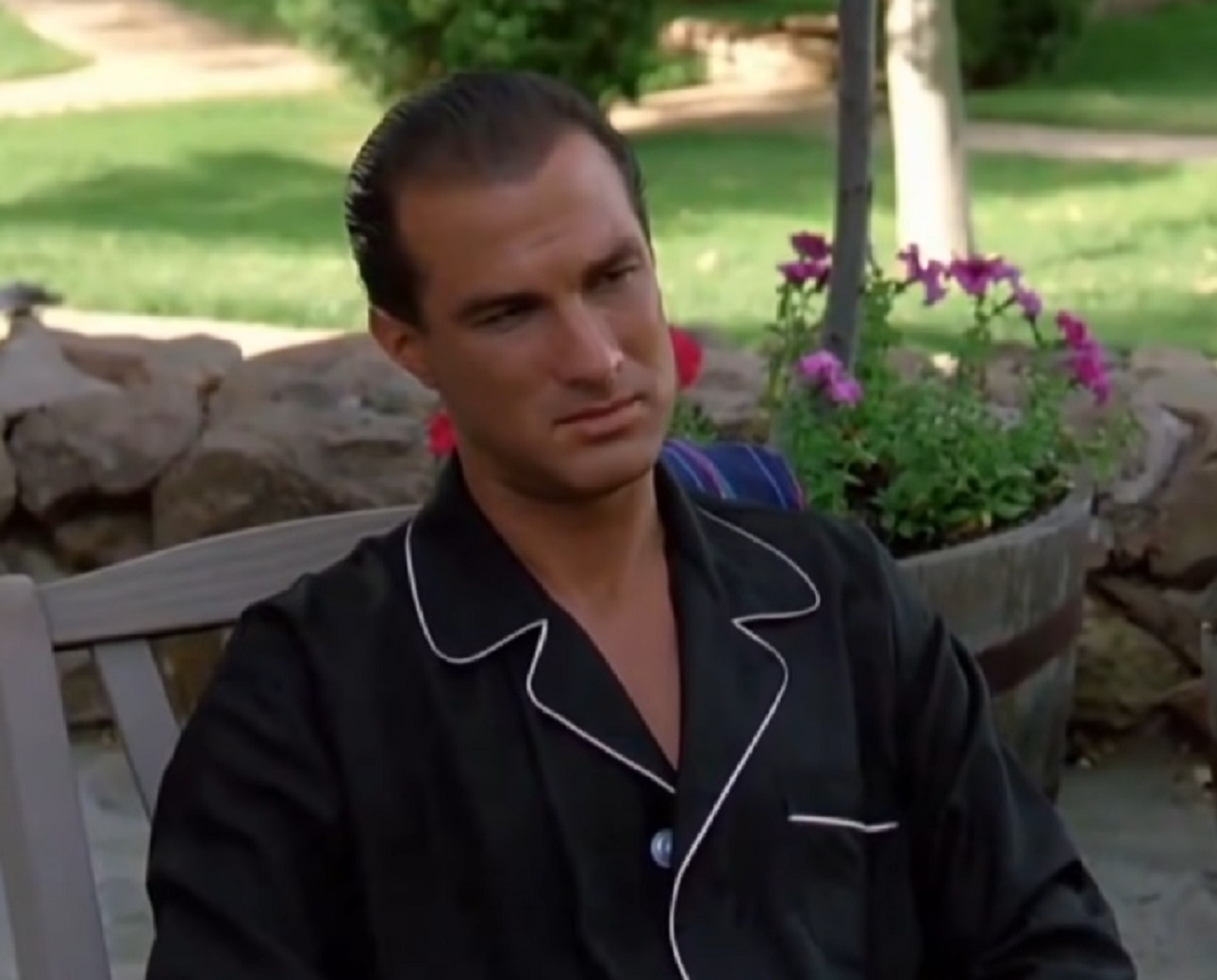 Screenshot: Steven Seagal seating outside - from Hard To Kill (1990)