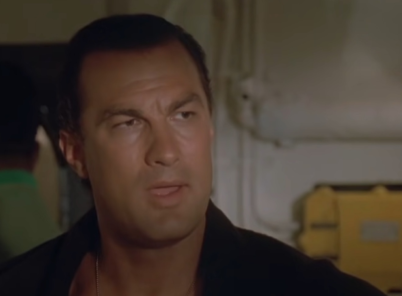 Screenshot: Steven Seagal is looking at side and talking - from Under Siege (1992)