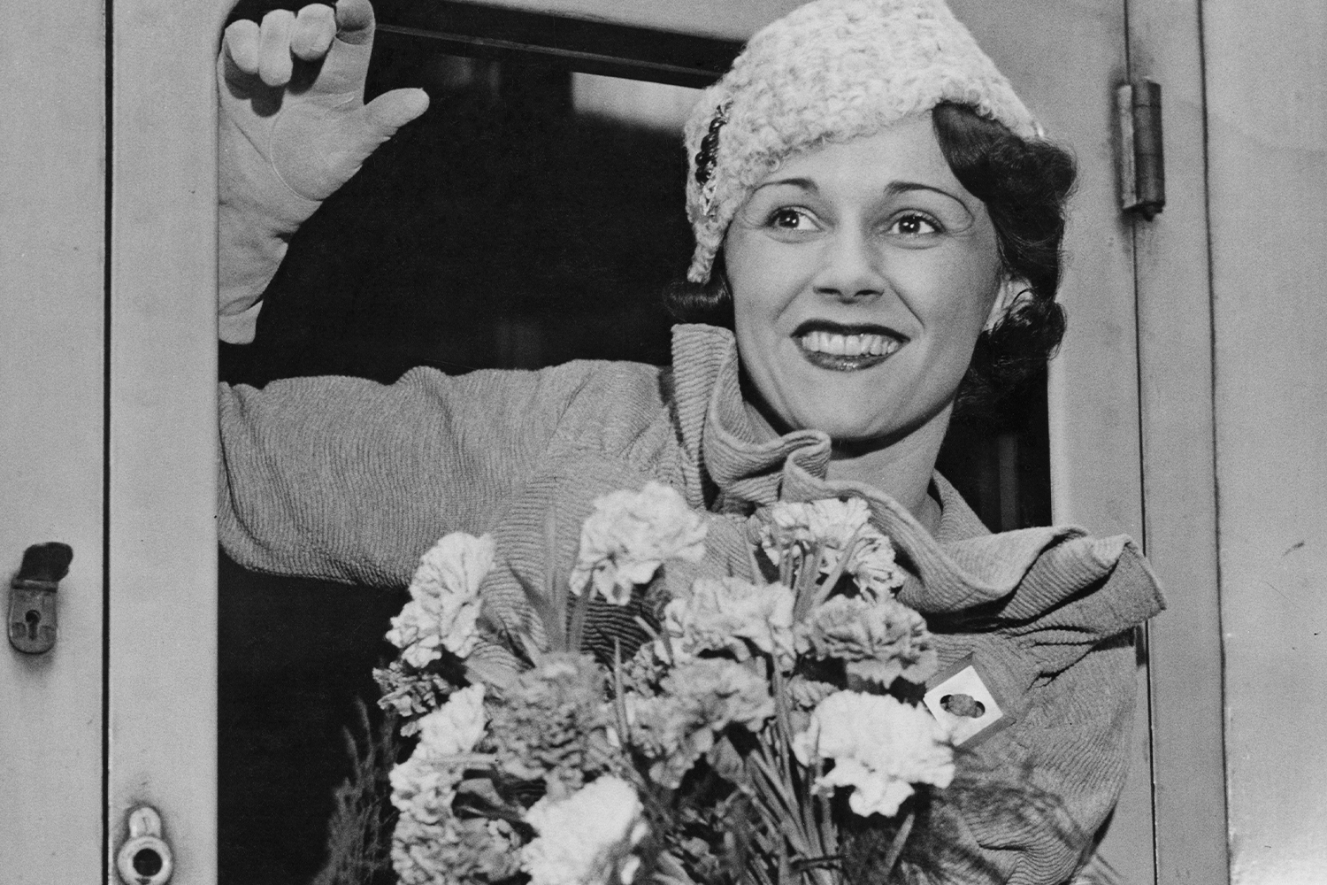 Benita Hume Holding Flowers