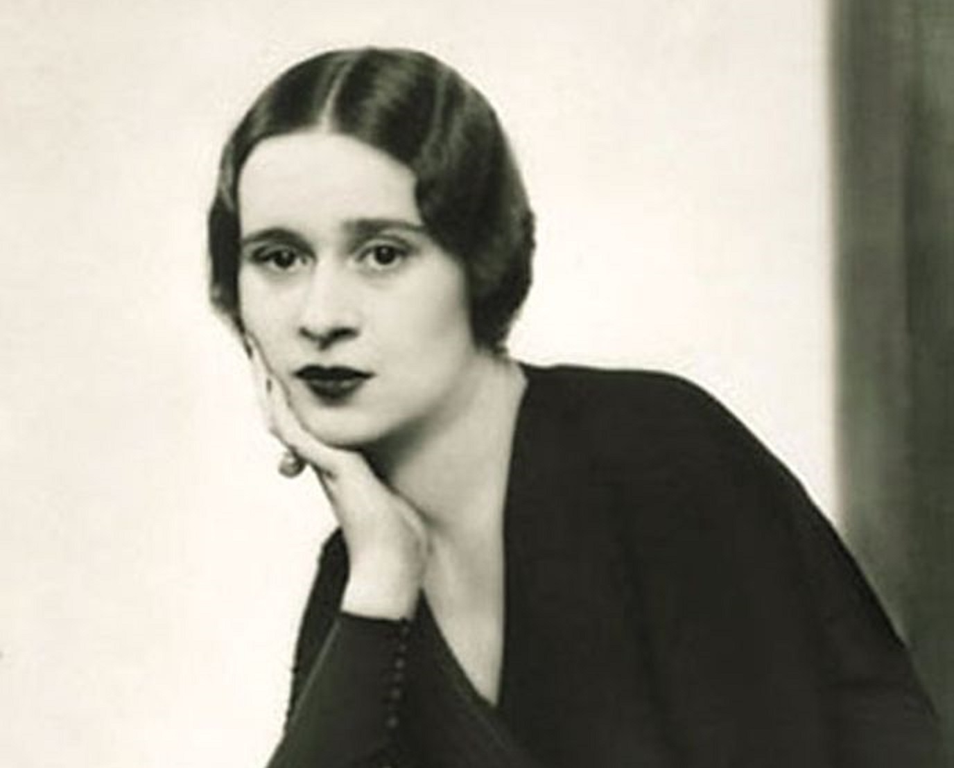 B&W portrait of Gloria Morgan Vanderbilt in black dress is looking at camera - 1933