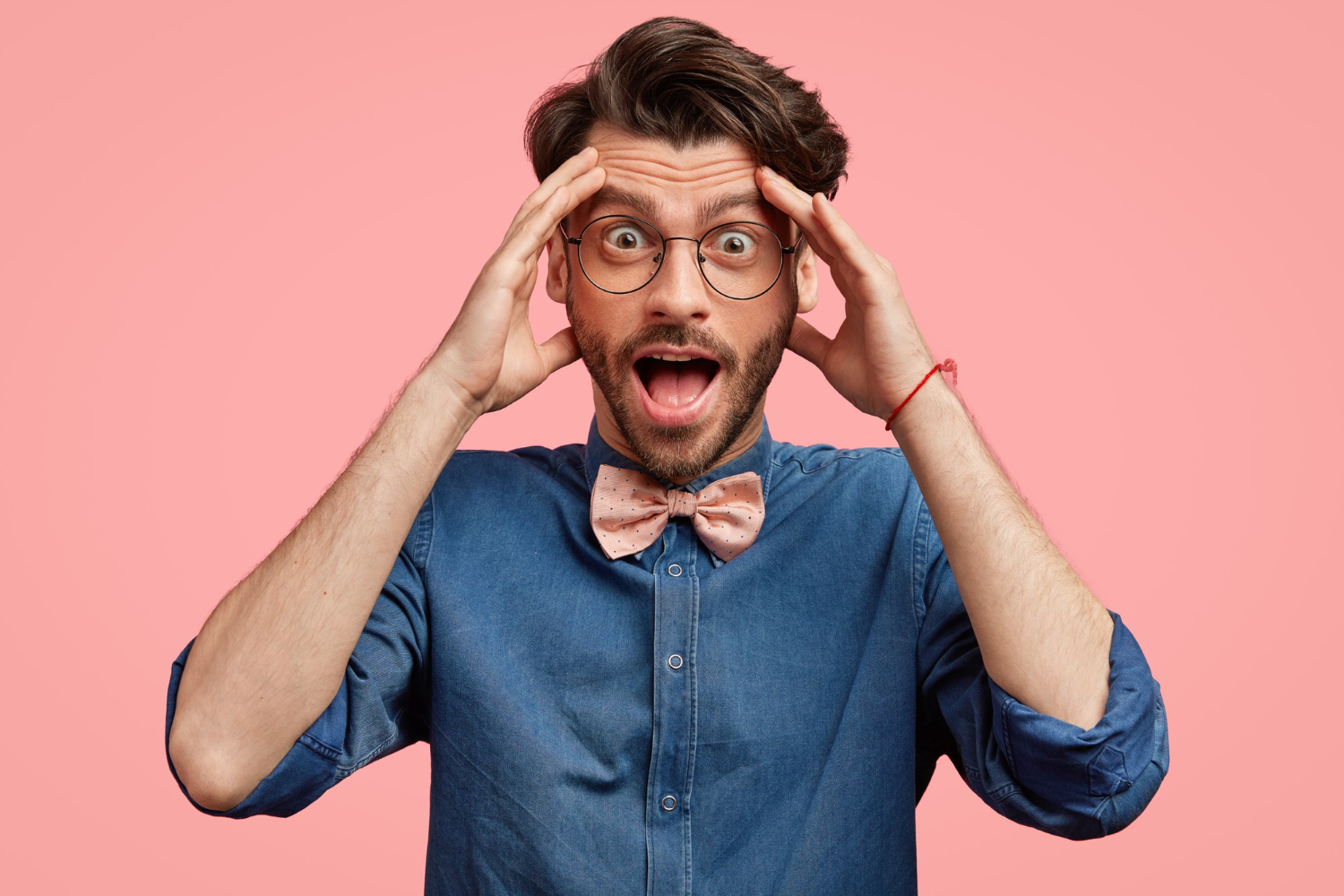 Bearded man is looking at camera with shocked face.