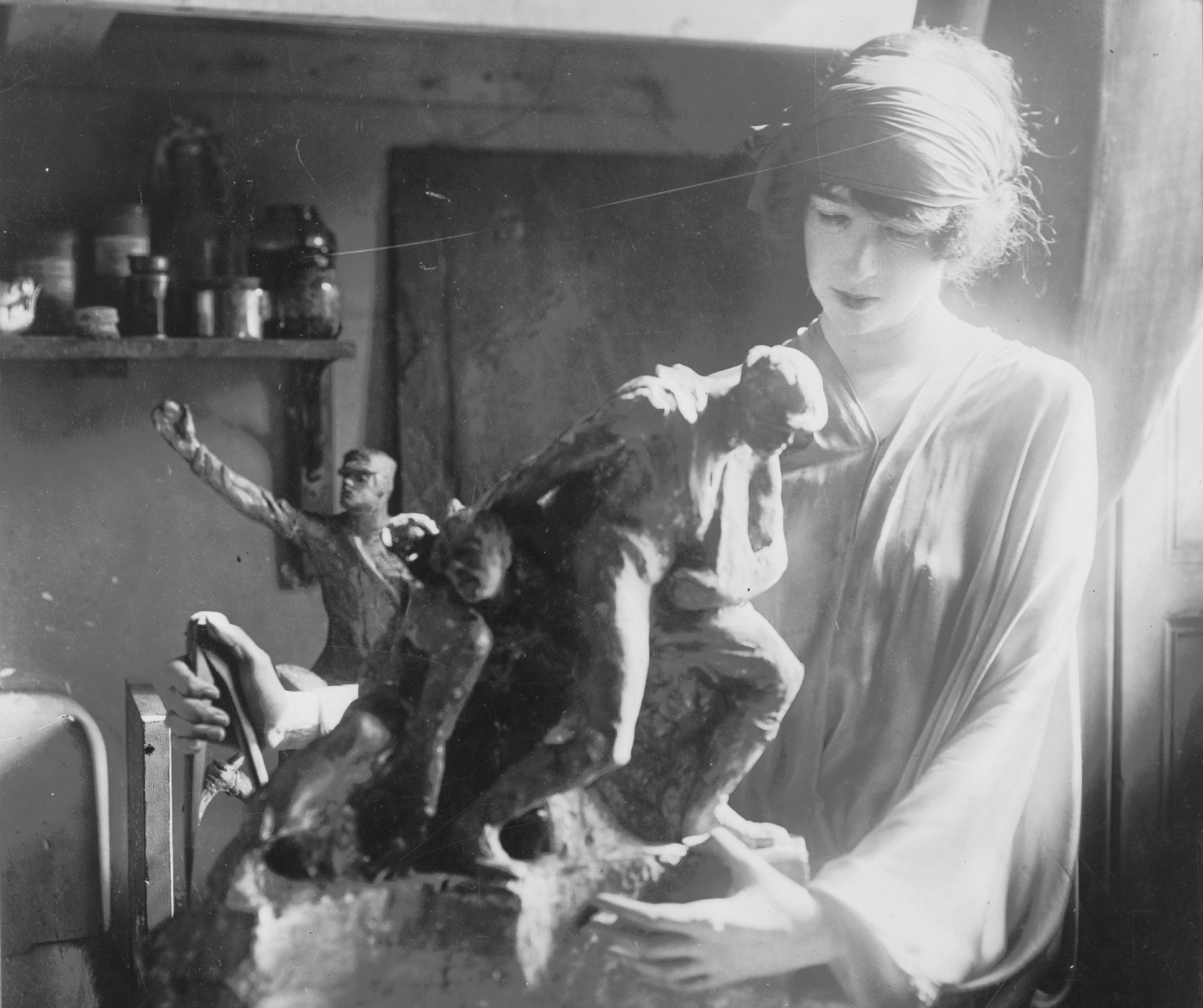 B&W photo of Gertrude Vanderbilt Whitney is making a sculpture in workshop - 1920