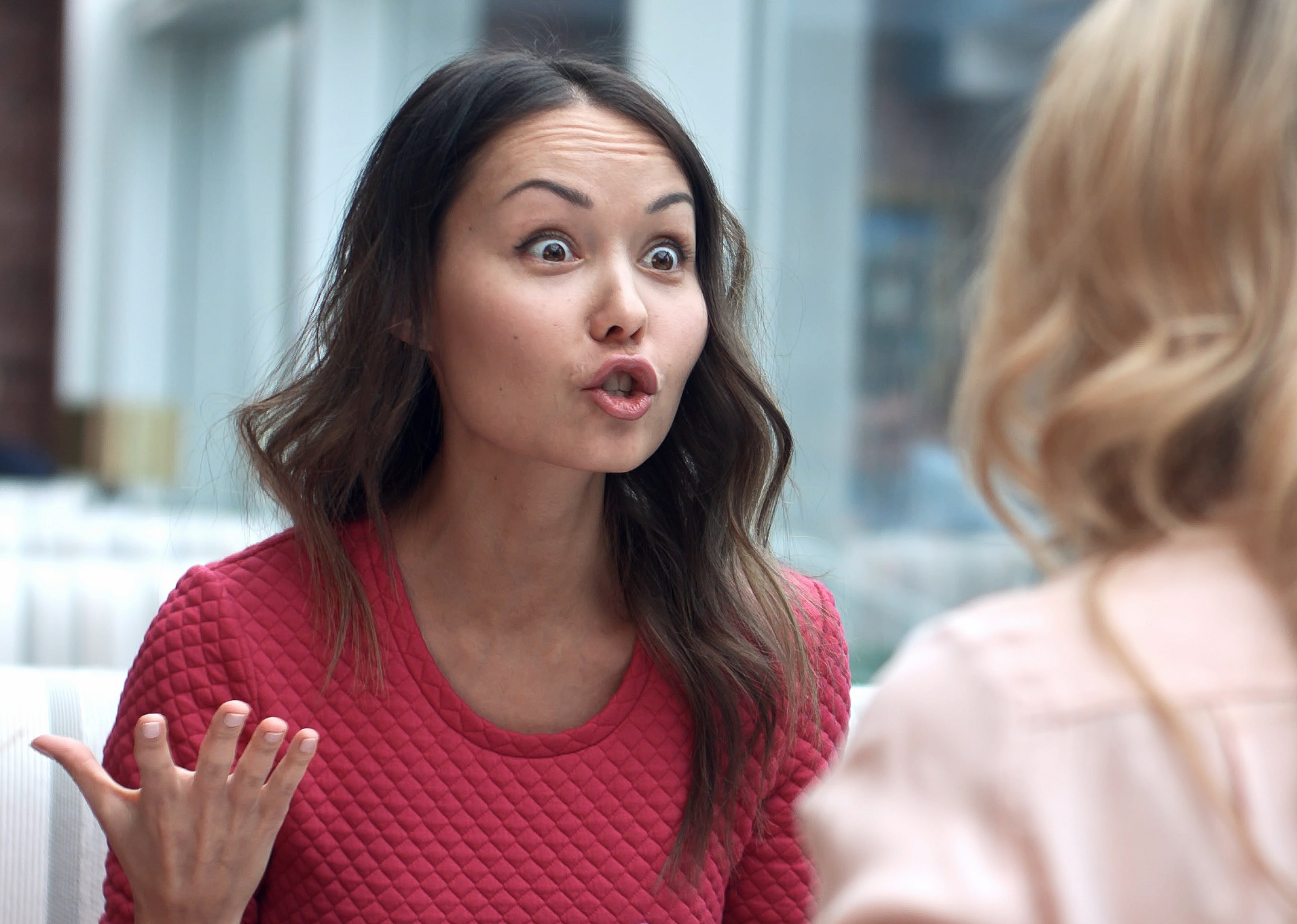 Woman is yelling and pointing to a other woman next to her.