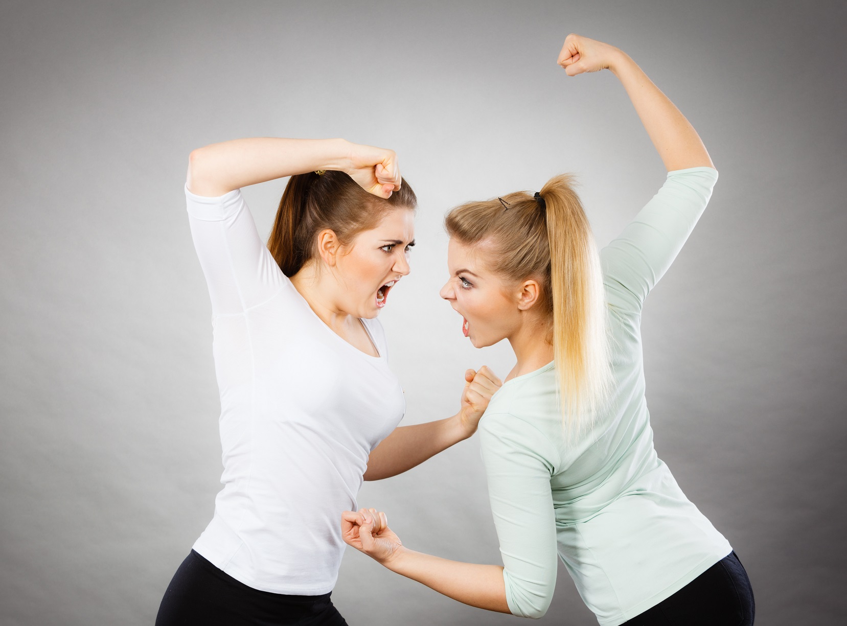 Two agressive women being mad at each other.