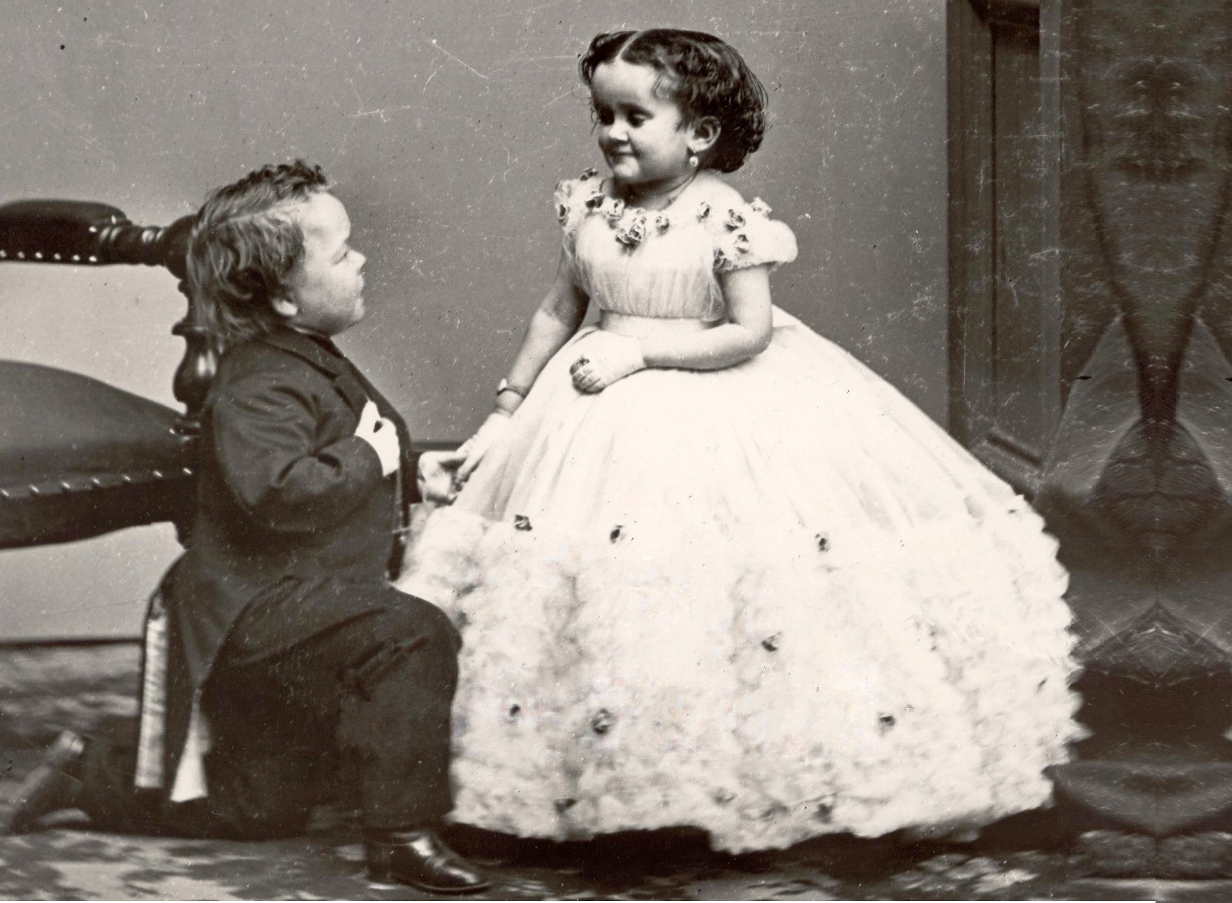 B&W photo of George Washington Morrison Nutt on his knee and Minnie Warren looking at him.
