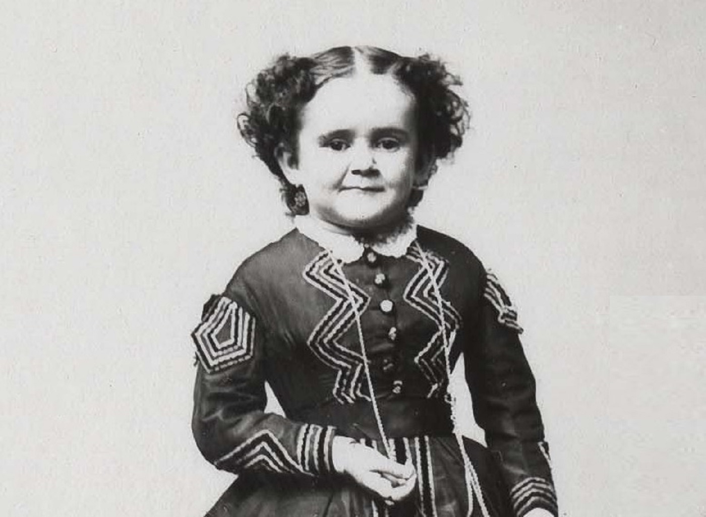 B&W photo of Minnie Warren wearing black dress and smiling - circa 1865