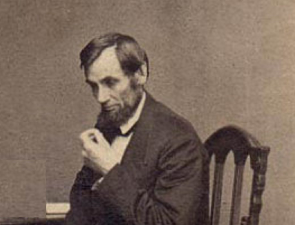 B&W image of Abraham Lincoln in black suit ,looking down - 1861