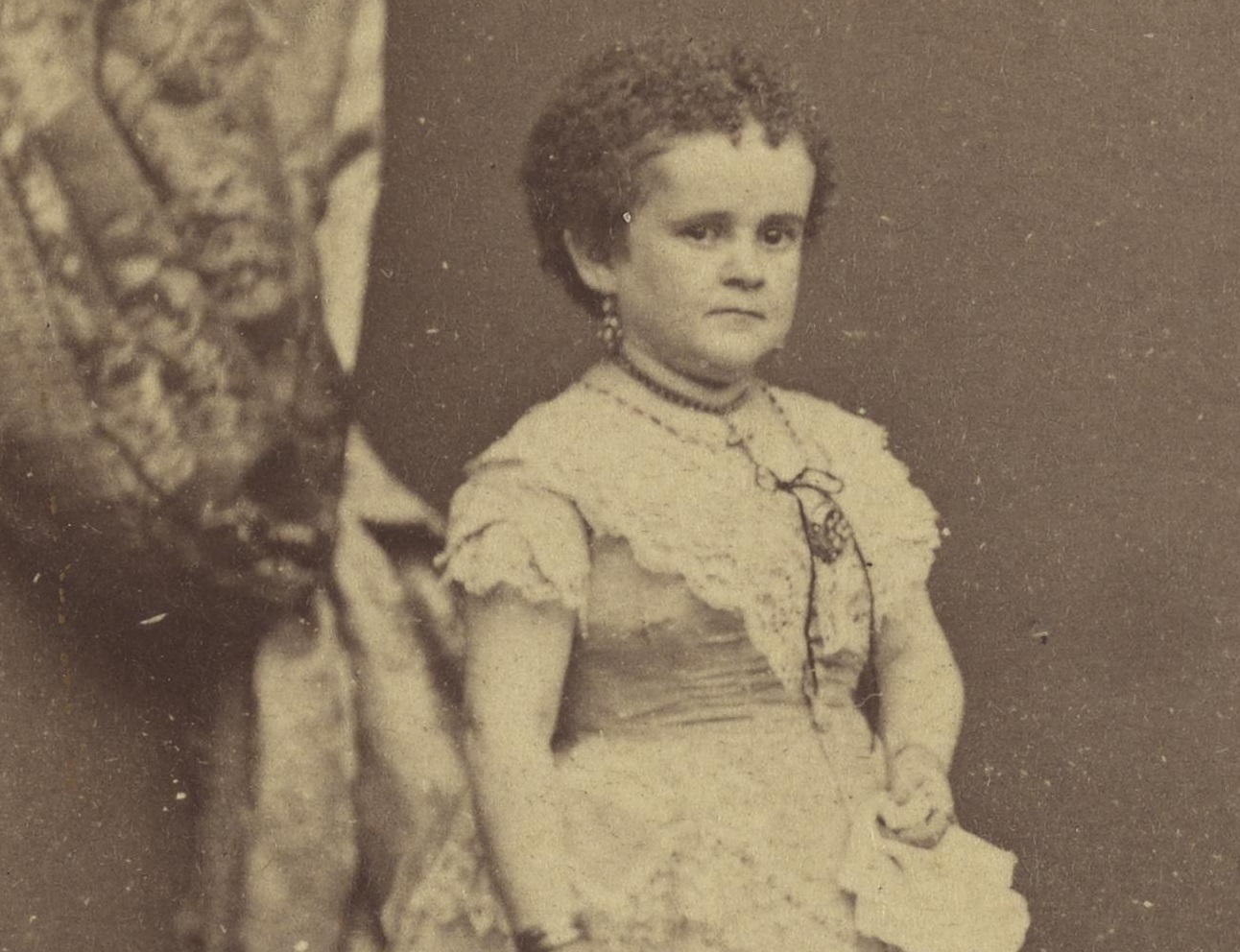 B&W photo of Lavinia Warren with short hair ,wearing white dress and looking at side - 1863