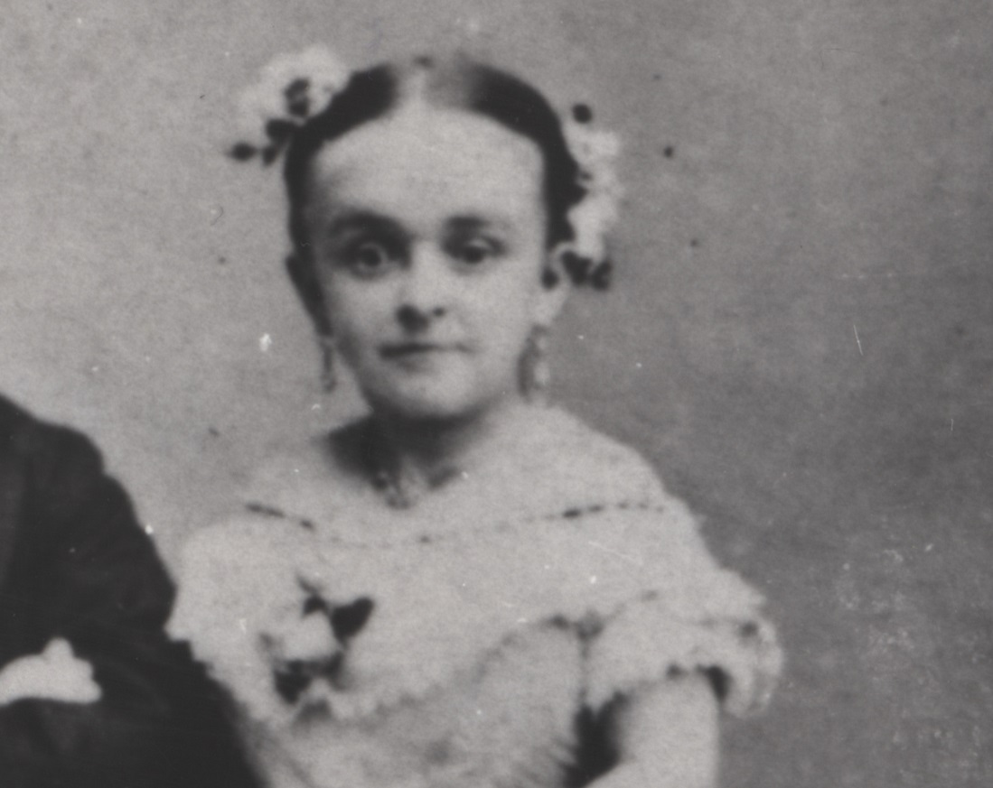 B&W photo of Lavinia Warren wearing white dress is looking at camera.