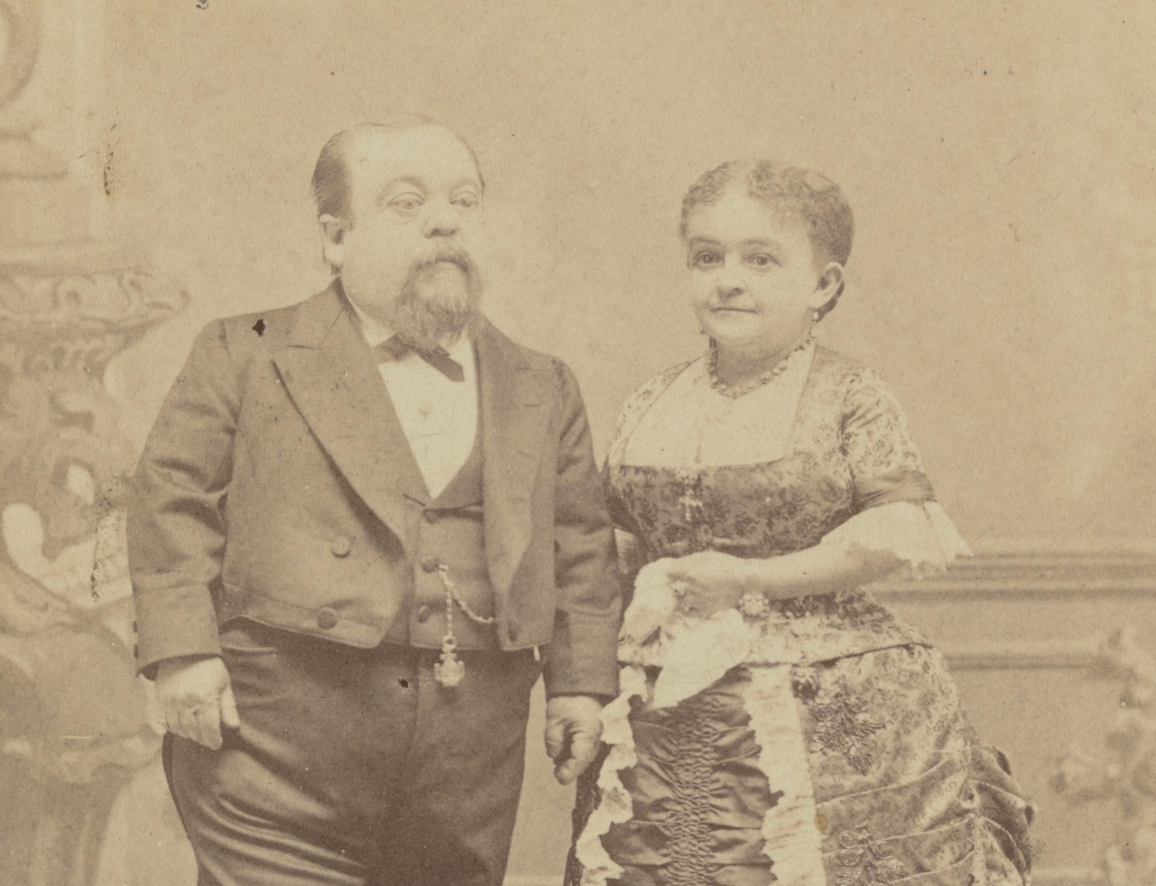 B&W portrait of Tom Thumb and Lavinia Warren wearing black and white clothes ,looking at side - 1880s