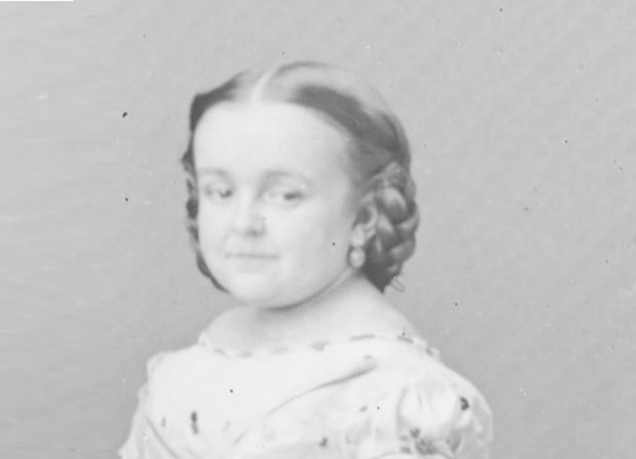 B&W photo of Lavinia Warren wearing white dress is smiling at camera - 1860s