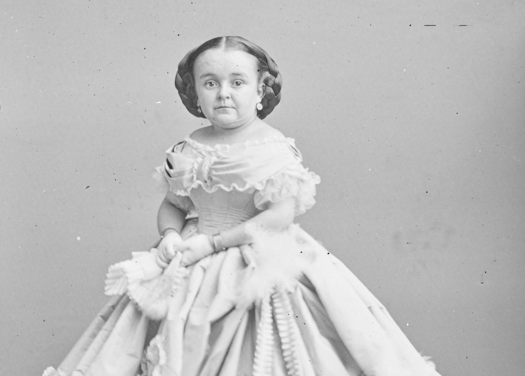 B&W photo of Lavinia Warren wearing white dress is looking at camera - 1860s