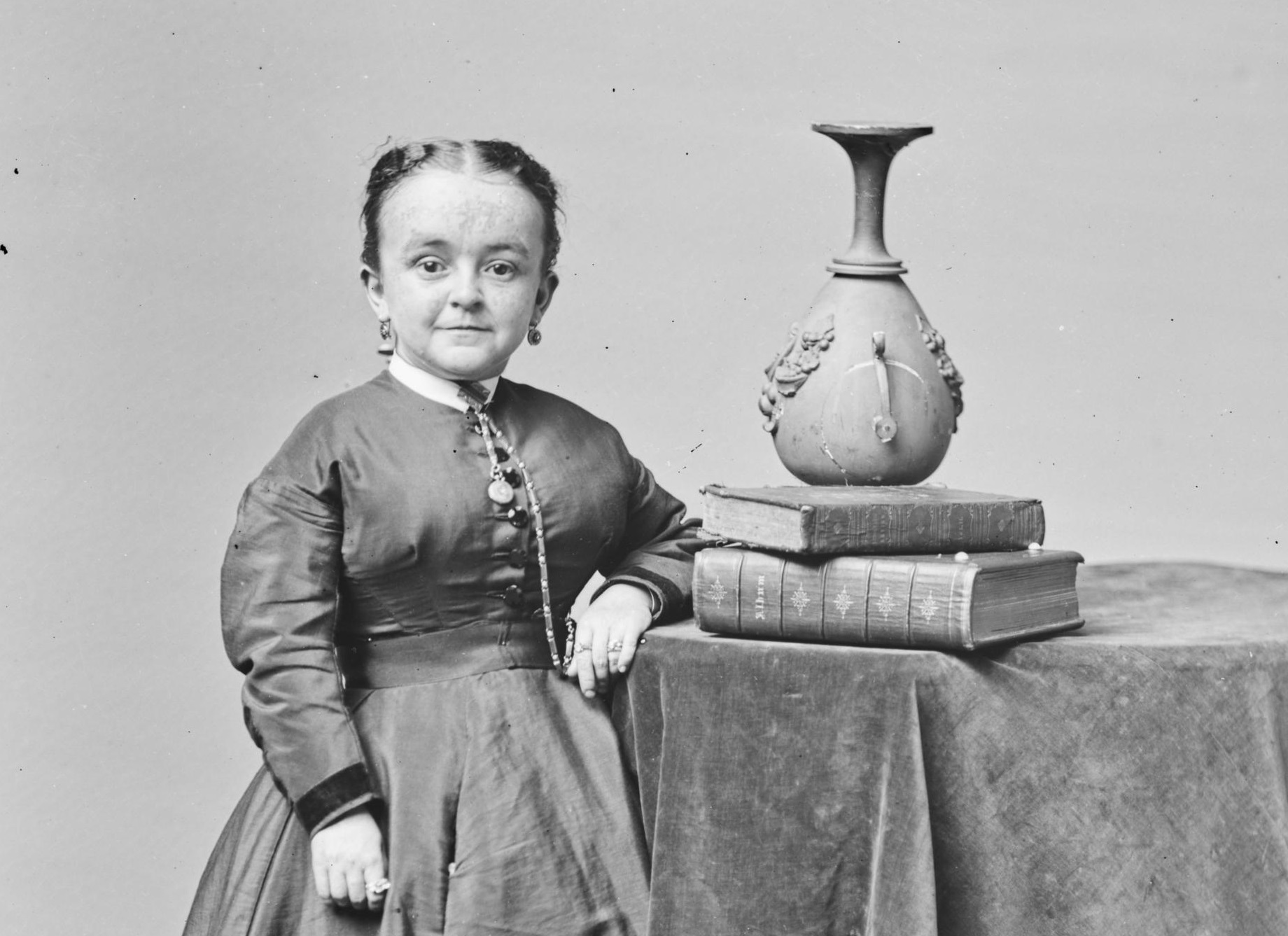 B&W photo of Lavinia Warren standing next to a table - 1860