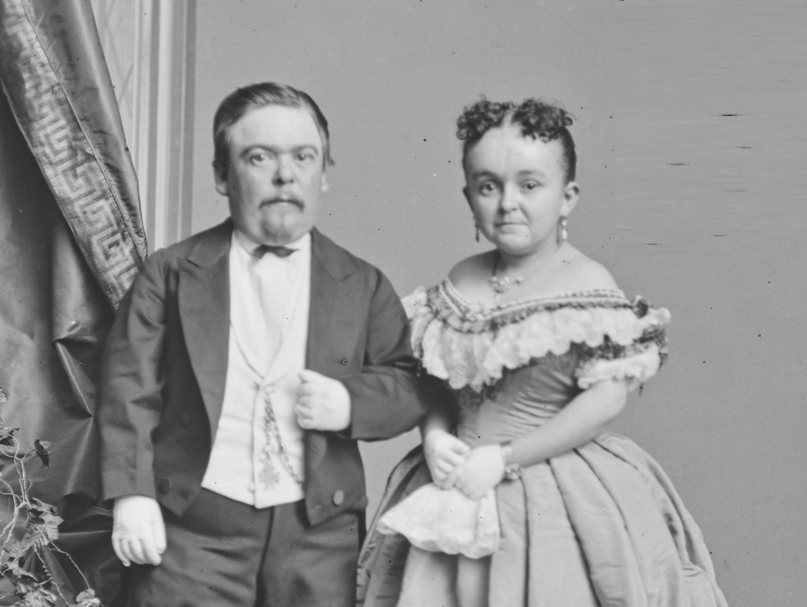 B&W photo of Charles and Lavinia Stratton wearing black suit and white dress ,looking at camera - 1860s