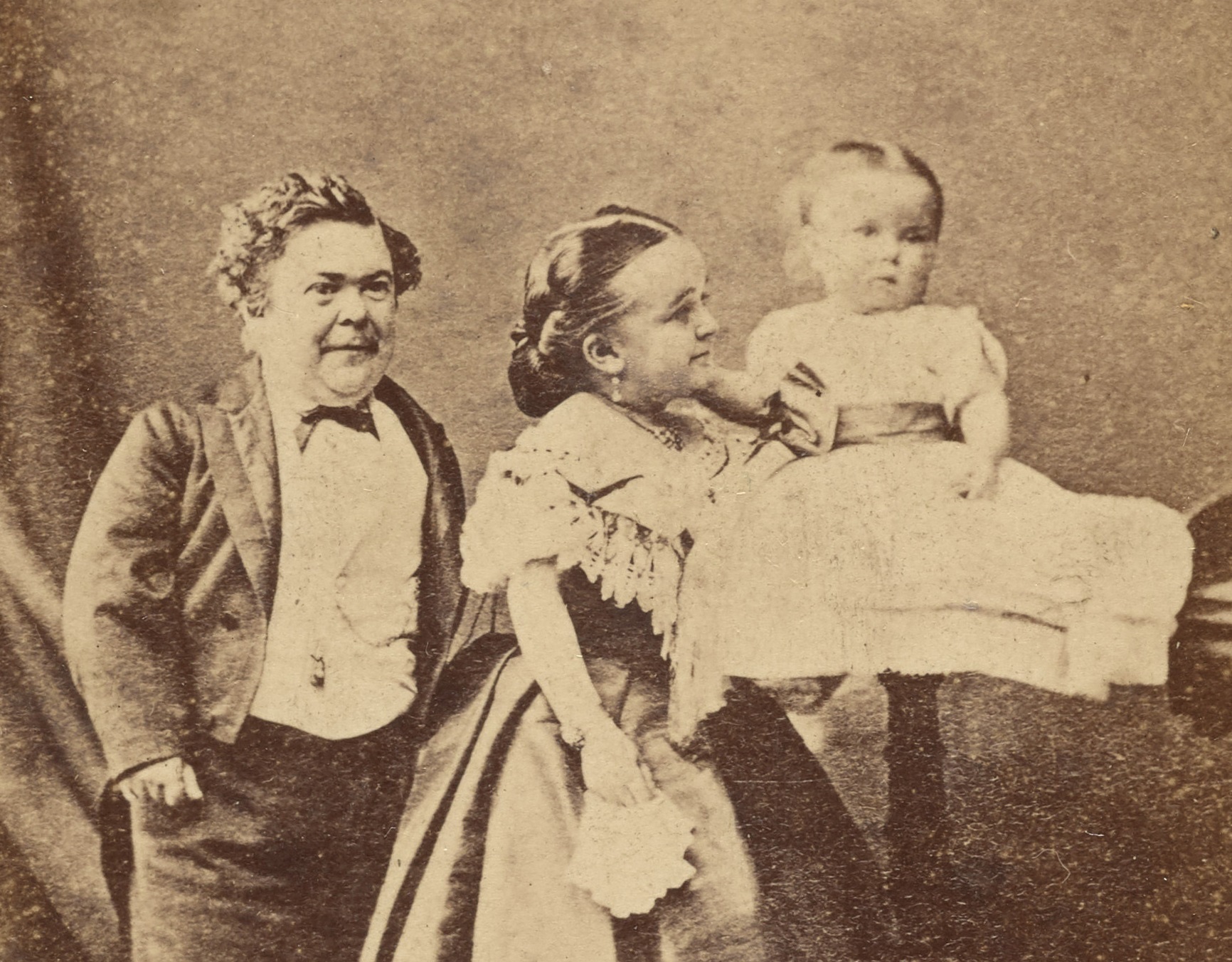 Charles Sherwood Stratton and Lavinia Warren holding a child - circa 1864-1875