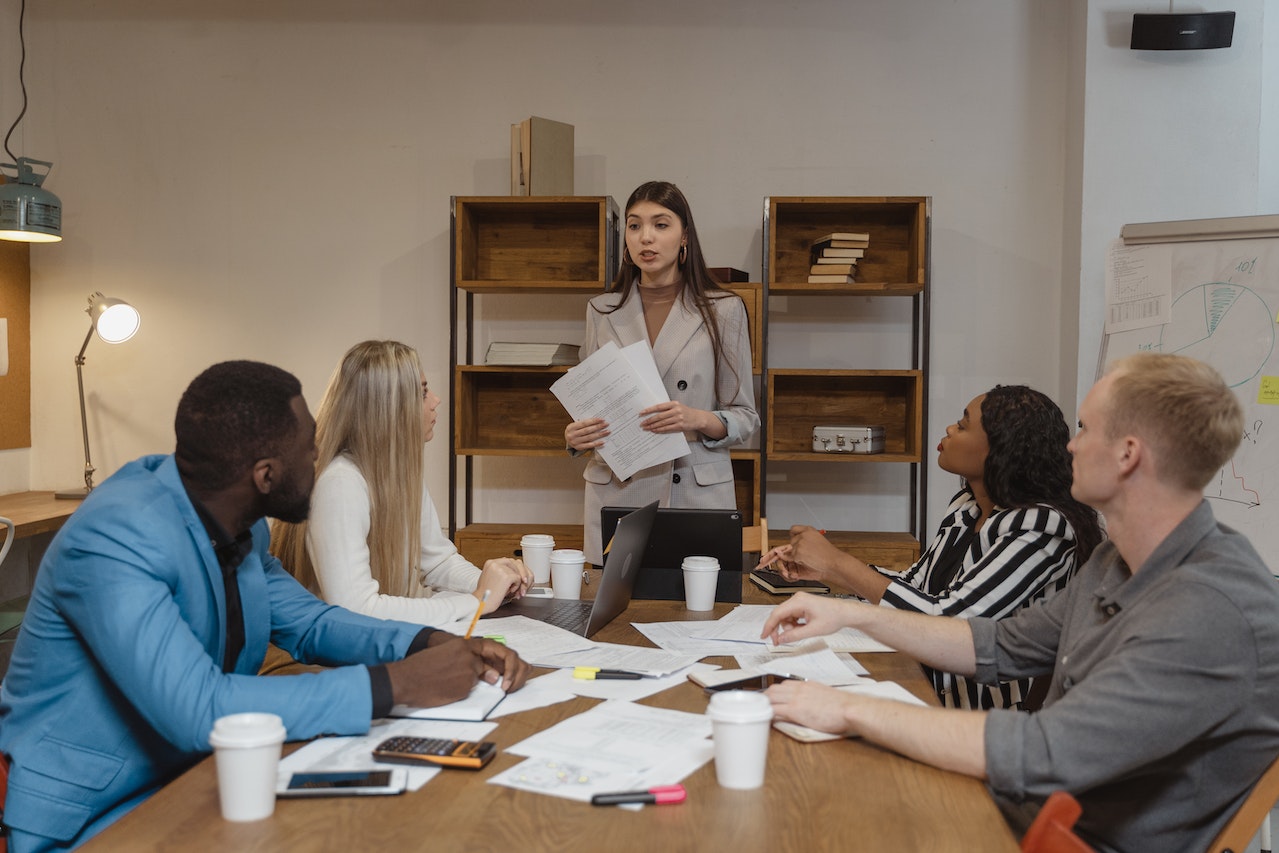 Woman in gray blazer is having a meeting at office.