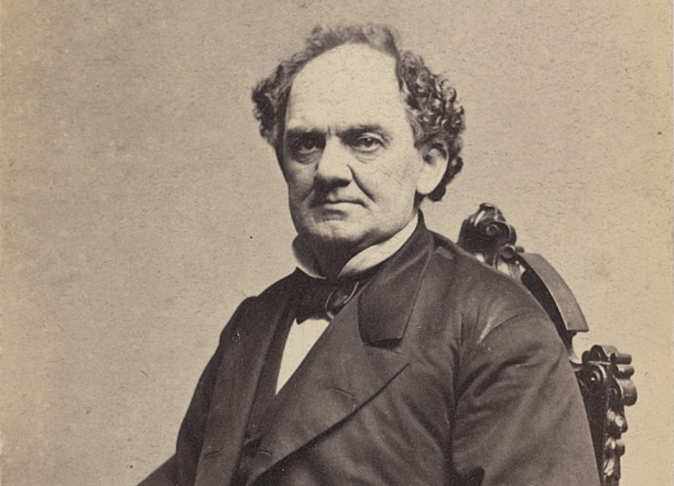 B&W photo of  P.t. Barnum seating on chair and looking at camera - 1861
