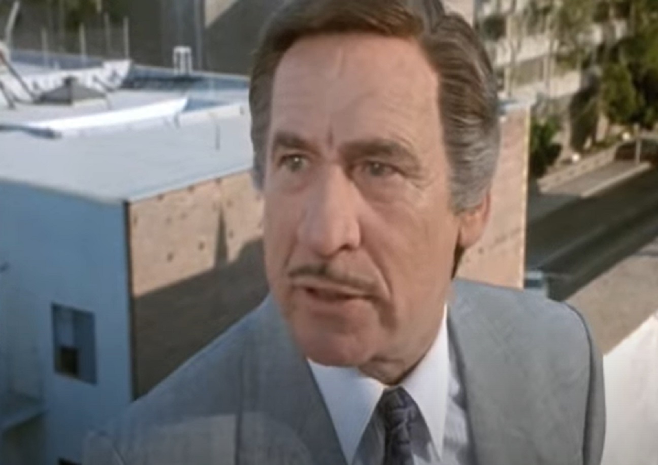 Mel Brooks wearing grey suit ,looking at side upset - from Life Stinks(1991)