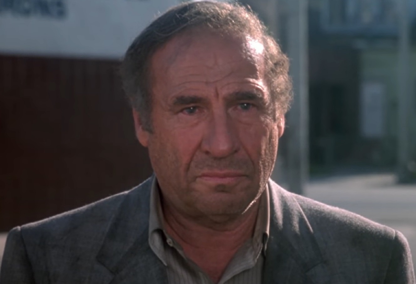 Mel Brooks wearing filthy grey suit looking sad - from Life Stinks (1991)