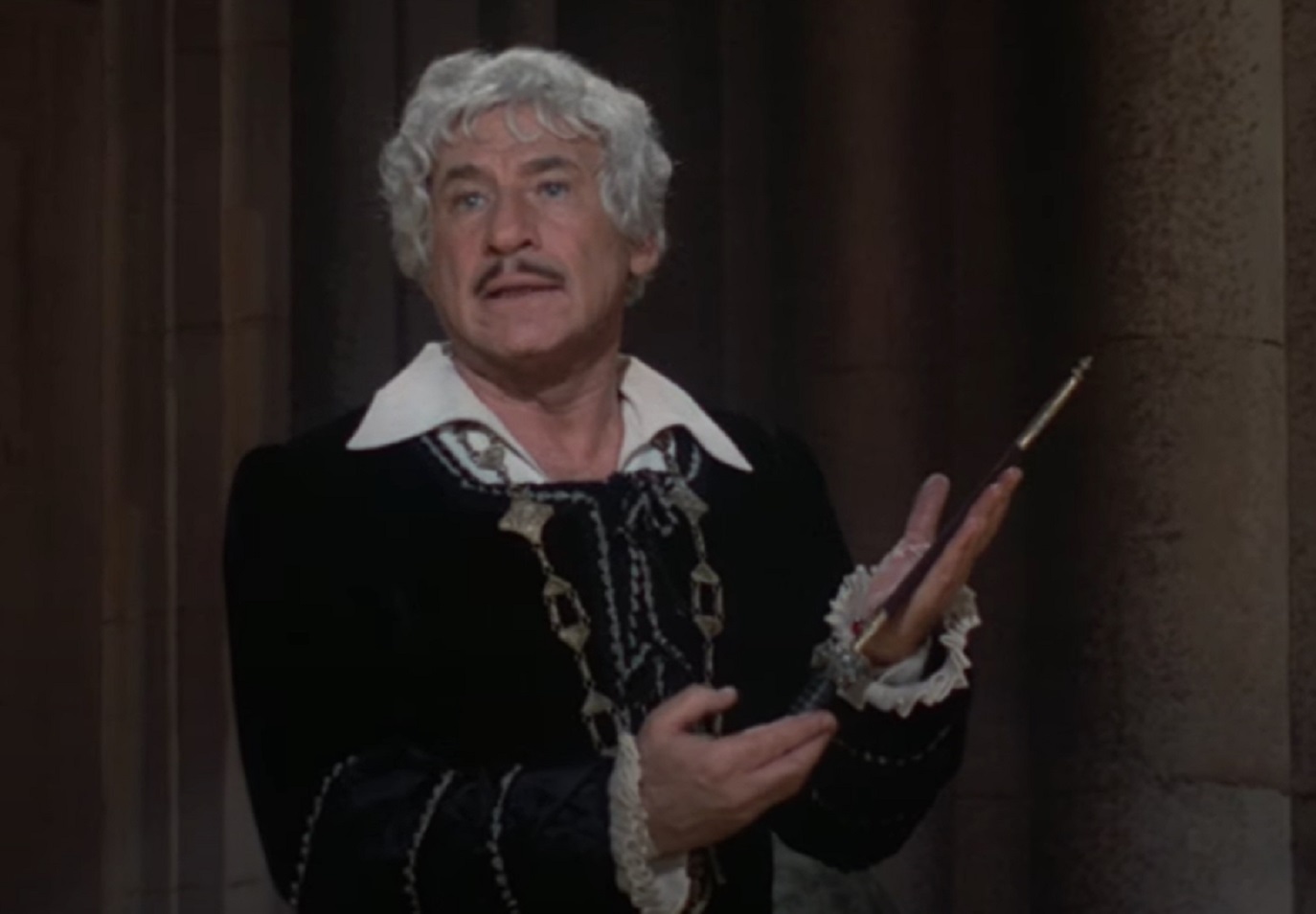 Screenshot: Mel Brooks is looking at side and talking - from To Be or Not to Be (1983)