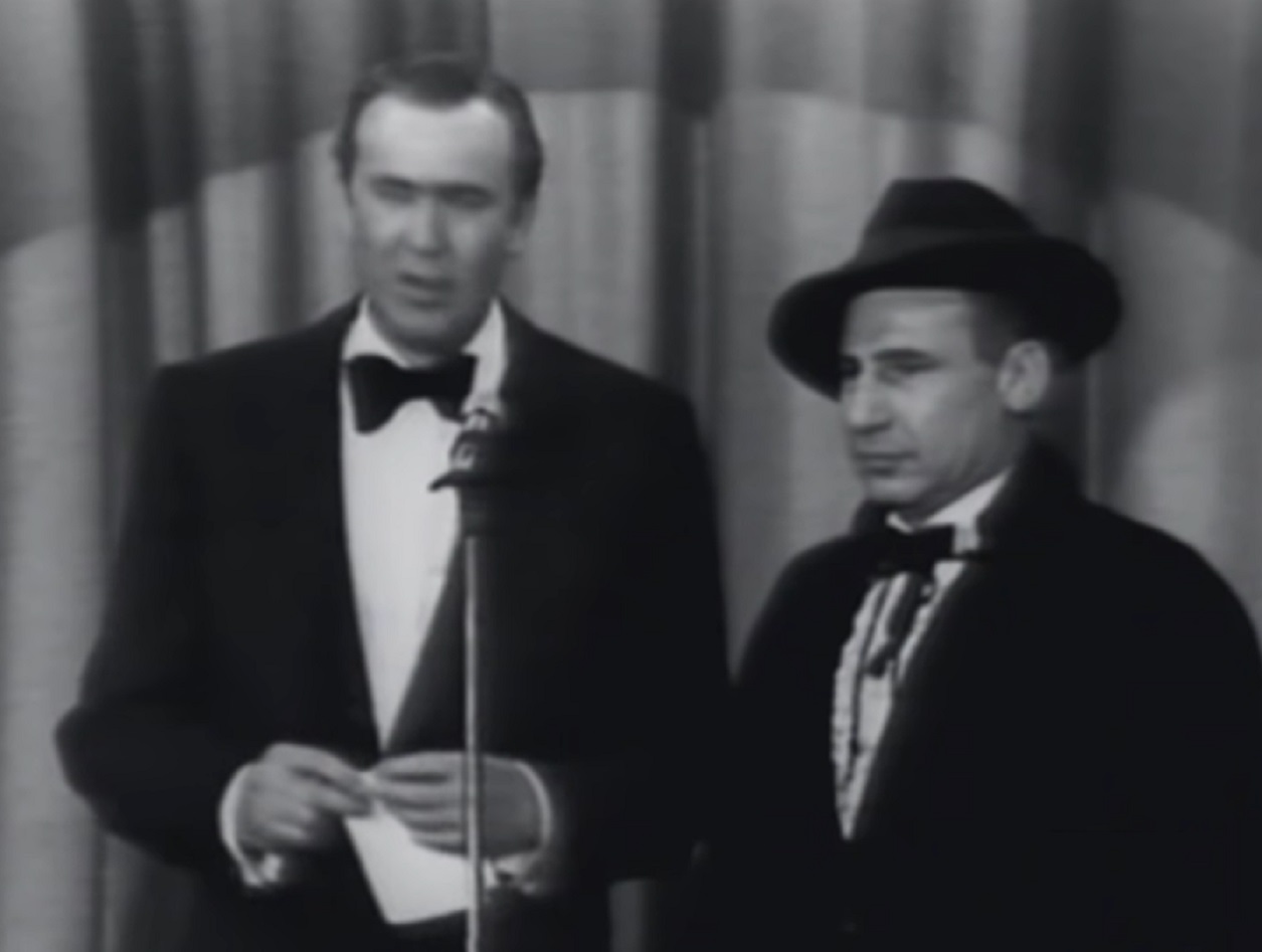 Mel Brooks wearing black suit and hat is performing on stage - from The Steve Allen Show (1952)