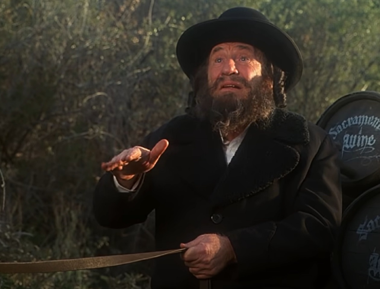 Screenshot: Mel Brooks wearing black coat beard and hat - from Robin Hood: Men in Tights (1993)