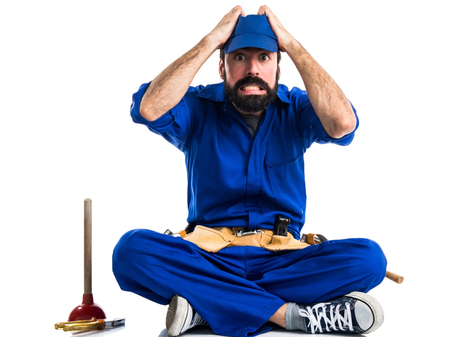 Bearded man is holding his head with surprised face, looking at camera.