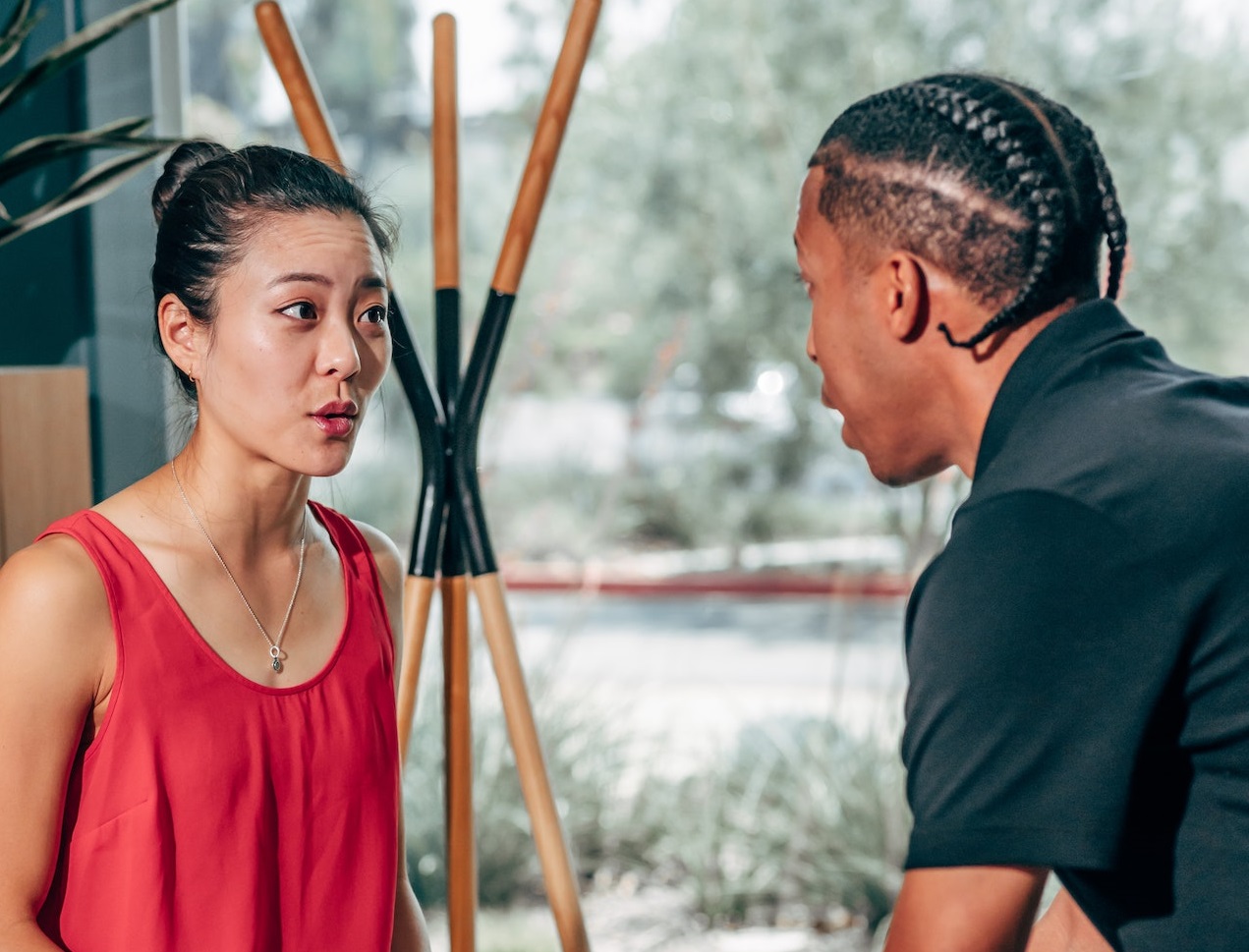 Young woman is arguing with male person at office.