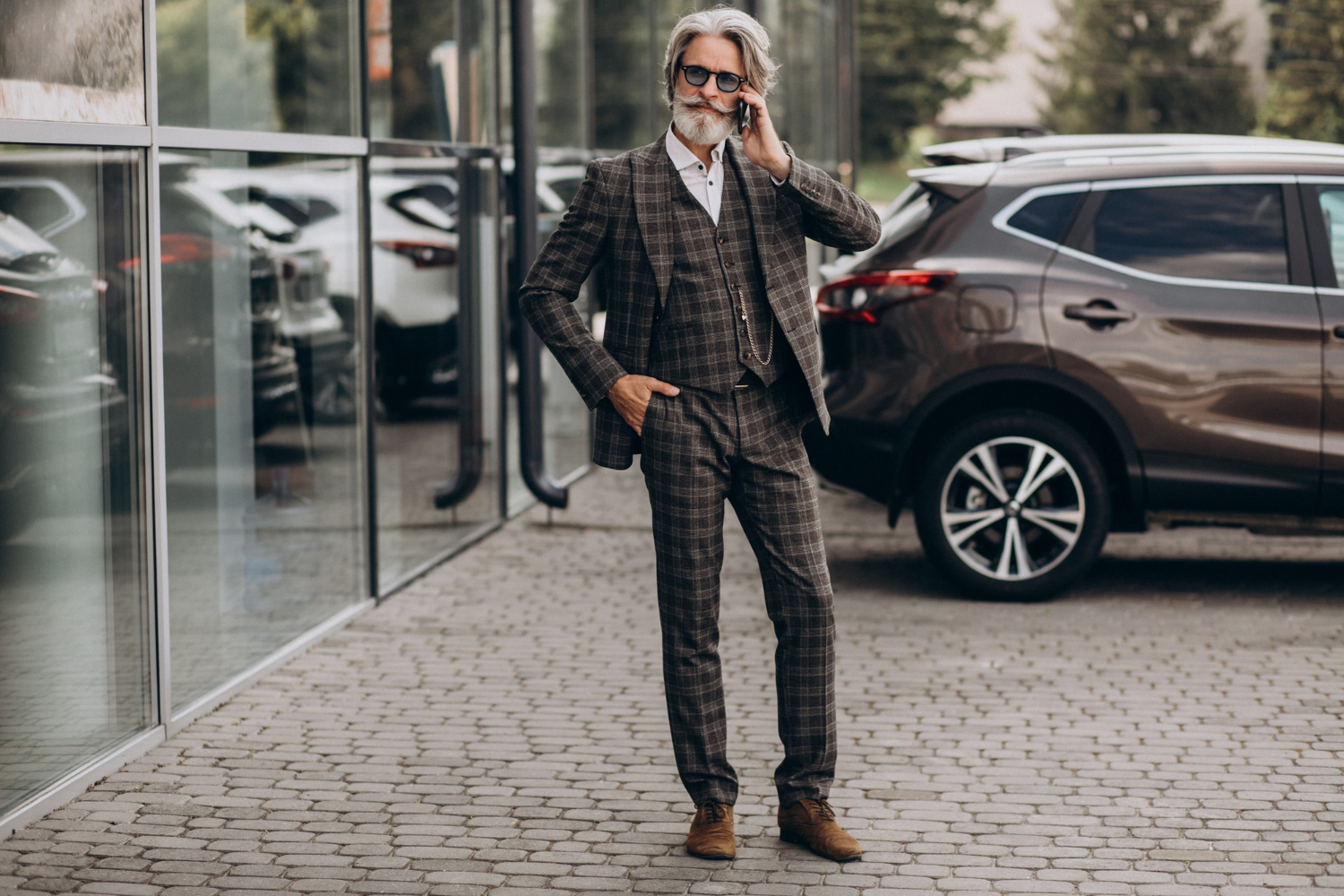 Senior business man is talking on the phone outside.