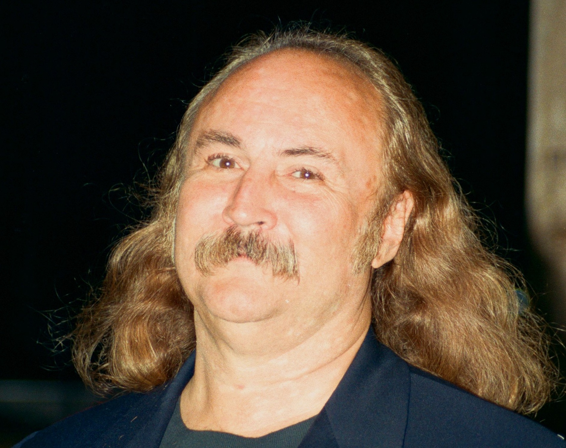David Crosby wearing blue jacket is smiling and looking at camera - 1995